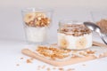 Ingredients for homemade oatmeal granola in glass jar. Oat flakes, honey, raisins and nuts. Healthy breakfast concept Royalty Free Stock Photo