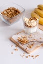 Ingredients for homemade oatmeal granola in glass jar. Oat flakes, honey, raisins and nuts. Healthy breakfast concept Royalty Free Stock Photo