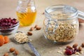 Ingredients for homemade oatmeal granola. Oat flakes, honey, almond nuts, dried cranberries and apricots. Healthy breakfast concep