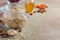 Ingredients for homemade oatmeal granola. Oat flakes, honey, almond nuts, dried cranberries and apricots. Healthy breakfast concep Royalty Free Stock Photo