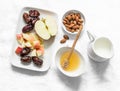 Ingredients for honey almonds apples protein smoothies on a light background, top view. Dates, almond milk, dates, honey, almonds Royalty Free Stock Photo