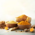 Ingredients for hot ayurvedic drink. Turmeric powder, curcuma root, cinnamon, ginger, lemon over grey background. Copy Royalty Free Stock Photo