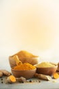 Ingredients for hot ayurvedic drink. Turmeric powder, curcuma root, cinnamon, ginger, lemon over grey background. Copy Royalty Free Stock Photo