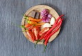 Ingredients of hot and spicy Sambal chili paste placed on wooden plate Royalty Free Stock Photo