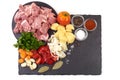 Ingredients for Hungarian goulash, isolated on white background. Place for text on a slate stone plate