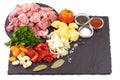 Ingredients for Hungarian goulash, isolated on white background. Place for text on a slate stone plate
