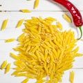 Penne Pasta, green basil, parmesan, sesame, garlic, chilli, eggs lie on a white tree table Royalty Free Stock Photo