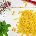 Penne Pasta, green basil, parmesan, sesame, garlic, chilli, eggs lie on a white tree table Royalty Free Stock Photo