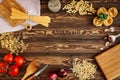 Ingredients for Italian Pasta on wooden table. Flat lay with free space for text. Royalty Free Stock Photo