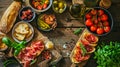 Ingredients for Italian snack, bruschetta, crostini or sandwich bar with Italian ham, sausage and antipasto on rustic wooden