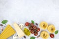 Ingredients for Italian spagetti Carbonara. Egg yolk, bacon, parmesan cheese, cream, fresh basil on gray background. Royalty Free Stock Photo