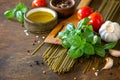 Ingredients for italy cuisine. Spinach spaghetti, herbs, spices, olive oil and tomatoes. Royalty Free Stock Photo