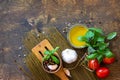 Ingredients for italy cuisine. Spinach spaghetti, herbs, spices, olive oil and tomatoes on a rustic table. Top view. Royalty Free Stock Photo
