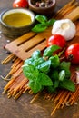 Ingredients for italy cuisine. Tomato spaghetti, herbs spices, olive oil and vegetables. Royalty Free Stock Photo