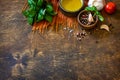 Ingredients for italy cuisine. Tomato spaghetti, herbs spices, olive oil and vegetables on a wooden table. Royalty Free Stock Photo