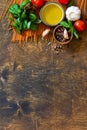 Ingredients for italy cuisine. Tomato spaghetti, herbs spices, olive oil and vegetables on a wooden table. Royalty Free Stock Photo