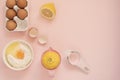 Ingredients and kitchen bake tools for cooking lemon cake or sweets - eggs, flour, hand juicer on a pastel punchy pink background.