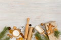 Ingredients and kitchen tools for cooking Christmas baking on light wood table top . Flour, eggs, rolling pin, cutters, sieve etc Royalty Free Stock Photo