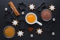 Ingredients with kitchen tools for dessert baking and star cookies on black background