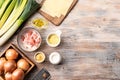 Ingredients for leek cheese soup with croutons and bacon on a wooden table. cheese, onion, leek, olive oil, bacon, garlic, mustard Royalty Free Stock Photo