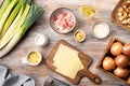 Ingredients for leek cheese soup with croutons and bacon on a wooden table. Royalty Free Stock Photo
