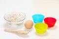 Ingredients for making biscuits: flour, egg, wooden spoon, silicone molds