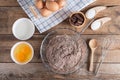 Ingredients for making cake chocolate on a wooden background.