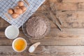 Ingredients for making cake chocolate on wooden background. Royalty Free Stock Photo