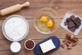 Ingredients for making chocolate chip cookies on a wooden background