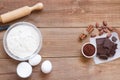 Ingredients for making chocolate chip cookies on a wooden background