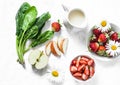 Ingredients for making coconut probiotic yogurt, spinach, apple, strawberry detox smoothie on a light background, top view