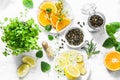 Ingredients for making cold aromatic green tea - dry green tea, lemon, orange, ginger, mint, rosemary on a light background, top v Royalty Free Stock Photo