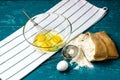 Ingredients for making the dough. A bag of flour, a hand whisk and a glass bowl with chicken eggs on a wooden table.