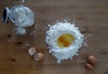 Ingredients for making fresh pasta, eggs and flour, on a wooden table Royalty Free Stock Photo