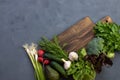 Ingredients for making green vegetarian salad. Green fresh bio vegetables next to a cutting board. Cooking at home. Copy space Royalty Free Stock Photo
