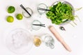 Ingredients for making mojito. Alcoholic refreshing summer drink. Mint, glass goblets, rum, syrup and lime on a white background