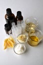 Ingredients for making natural cosmetics cacao butter, coconut, almond, jojoba and essential oils with tubes and bottles