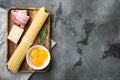 Ingredients for making pasta alla carbonara prosciutto, raw pasta, on gray stone background, top view flat lay, with copy space Royalty Free Stock Photo