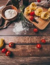 Ingredients for making pasta, flour, on a vintage wooden cutting board Royalty Free Stock Photo