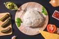 Ingredients for making pizza. dough, pickles, onions, cheese, mushrooms, Basil tomato sauce, garlic. top view flat lay Royalty Free Stock Photo