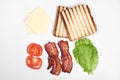 Ingredients for making sandwich. fresh vegetables, tomatoes, bread, becon, cheese. Isolated on white background, top