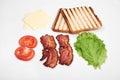 Ingredients for making sandwich. fresh vegetables, tomatoes, bread, becon. Isolated on white background, top view, copy