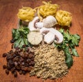 Ingredients nest pasta walnuts raisins herbs mushrooms on a cutting board wooden rustic background close up