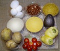 Fast food ingredients: eggs, peanuts, rice, bulgur, cherry tomatoes, bay leaf, corn grits, sweet pepper, avocado Royalty Free Stock Photo