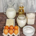 Ingredients for pancakes: milk, eggs, sugar, salt, flour, vegetable oil on a wooden white background. Royalty Free Stock Photo