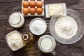 Ingredients for pancakes: milk, eggs, sugar, salt, flour, vegetable oil on a wooden white background. Royalty Free Stock Photo