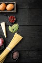Ingredients for Pasta Carbonara. Traditional Italian food, on black wooden background, top view flat lay, with copy space for text Royalty Free Stock Photo