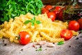 Ingredients for pasta: organic cherry tomatoes, fresh basil fusilli, garlic and olive oil Royalty Free Stock Photo