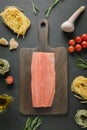 Ingredients for pasta tagliatelle with trout on chopping board. View from above