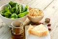 Ingredients for pesto: basil, pine nuts, garlic, parmesan and olive oil on wooden background. Healthy eating concept Royalty Free Stock Photo